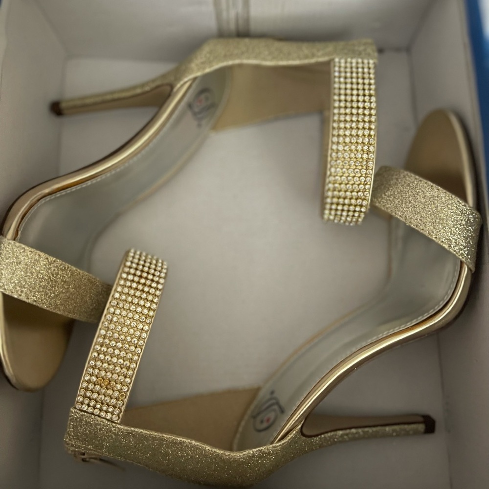 Gold single strap heels.